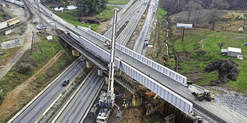 construction guy looking at a track hoe